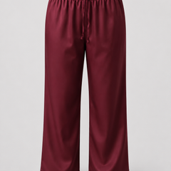 A pair of wide-leg cropped pants in a deep burgundy color, featuring an elastic waistband and a drawstring, shown against a light gray background.