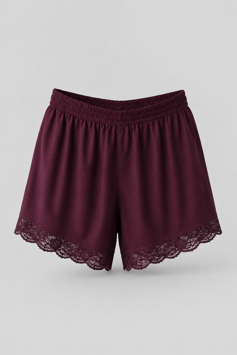 A pair of women's shorts in deep burgundy with a matching elastic waistband and delicate lace trim along the hem, displayed against a neutral light gray background.