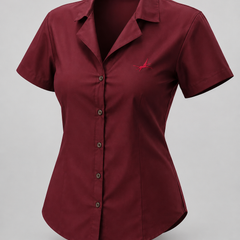 A short-sleeve button-up shirt in deep burgundy, featuring a structured collar, dark buttons, and a small red embroidered bird logo on the left chest, displayed on a neutral gray background.