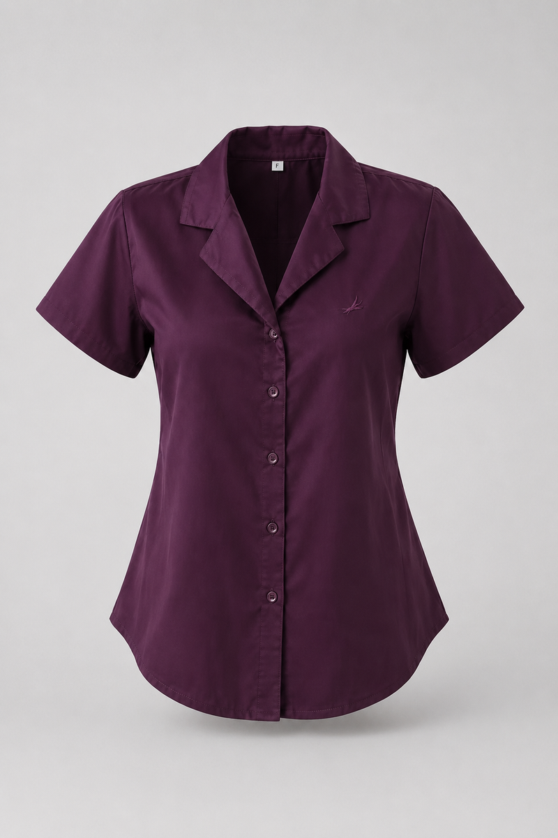 A short-sleeve button-up shirt in deep plum purple, featuring a notched lapel collar and a small embroidered logo on the left chest, displayed on a neutral gray background.