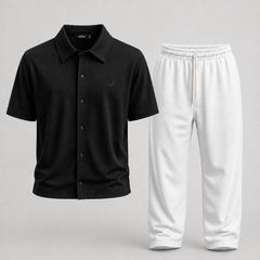 A two-piece clothing set featuring a black short-sleeve button-up shirt and white sweatpants, displayed against a neutral light gray background.