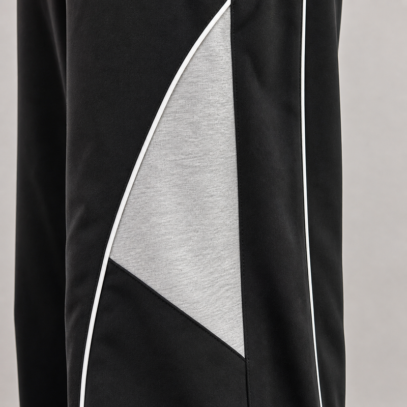 Black and gray athletic pants with a geometric design on a light gray background