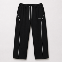 Black pants with white drawstring and piping on a light gray background