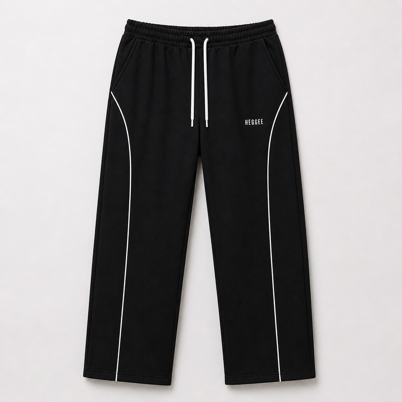 Black pants with white drawstring and piping on a light gray background