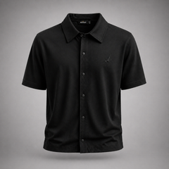 Black short-sleeve shirt with button details on a gray background