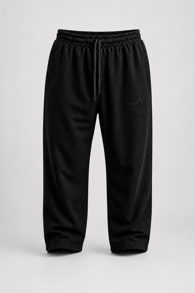 Black trouser with drawstring on a light grey background.