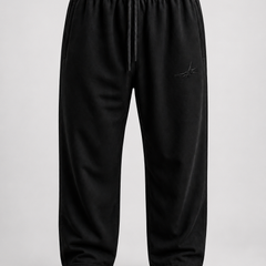 Black trouser with drawstring on a light grey background.