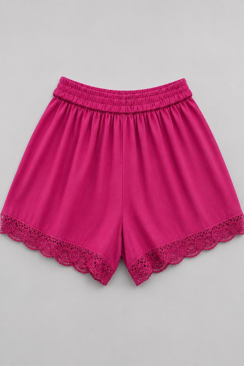 Bright pink athletic shorts with a matching elastic waistband and scalloped lace trim at the hem, shown flat on a neutral gray background.