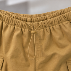 Close-up of Mustard yellow pants with a drawstring on a blurred background