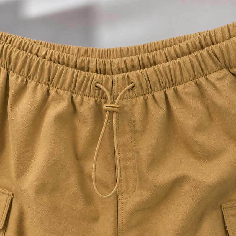 Close-up of Mustard yellow pants with a drawstring on a blurred background