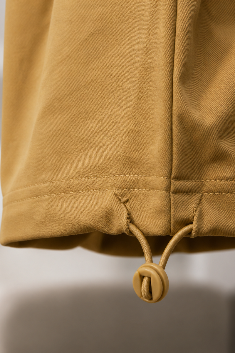 Close-up of a Mustard yellow jacket with a blurred background