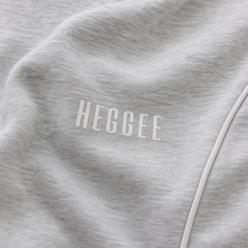 Close-up of a gray fabric with 'HEGGEE' branding.