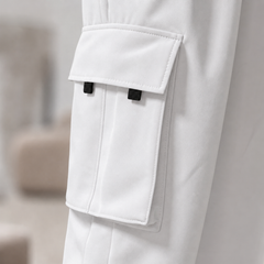 Close-up of a white coat with black buttons on a blurred background