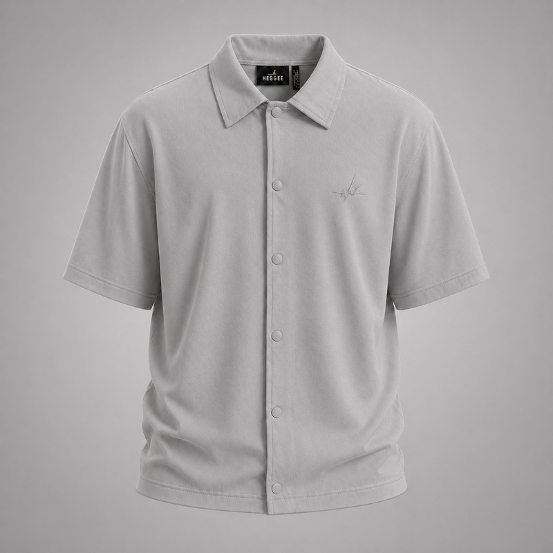 Gray short-sleeve shirt with a brand label on a gray background