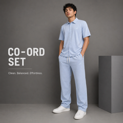 Man wearing a light blue coord set with text on a gray background