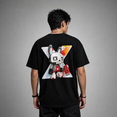 Person wearing a black t-shirt with a graphic design on the back against a gray background