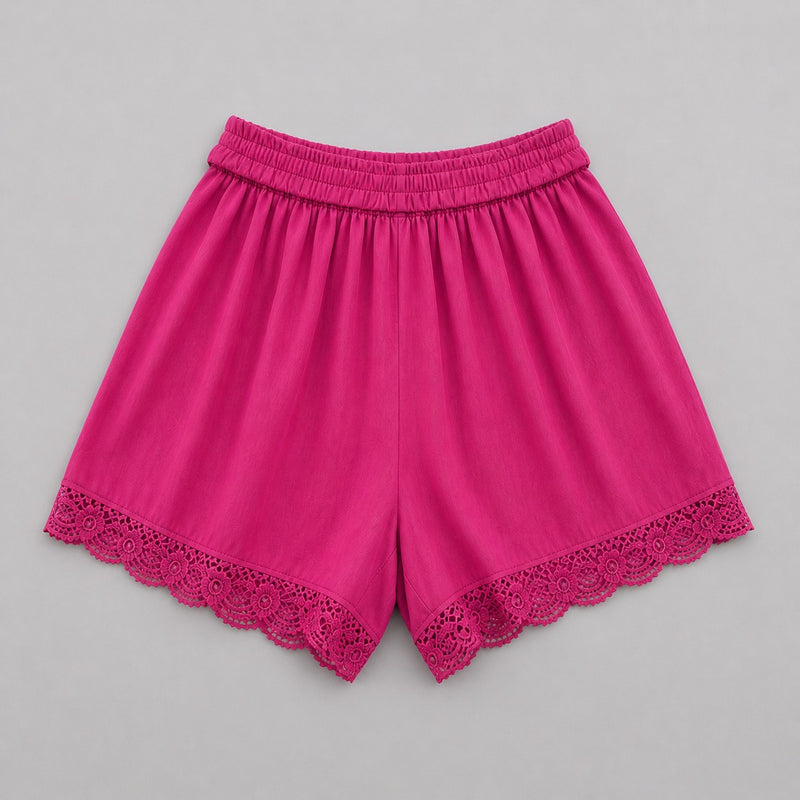 Pink shorts with lace trim on a gray background