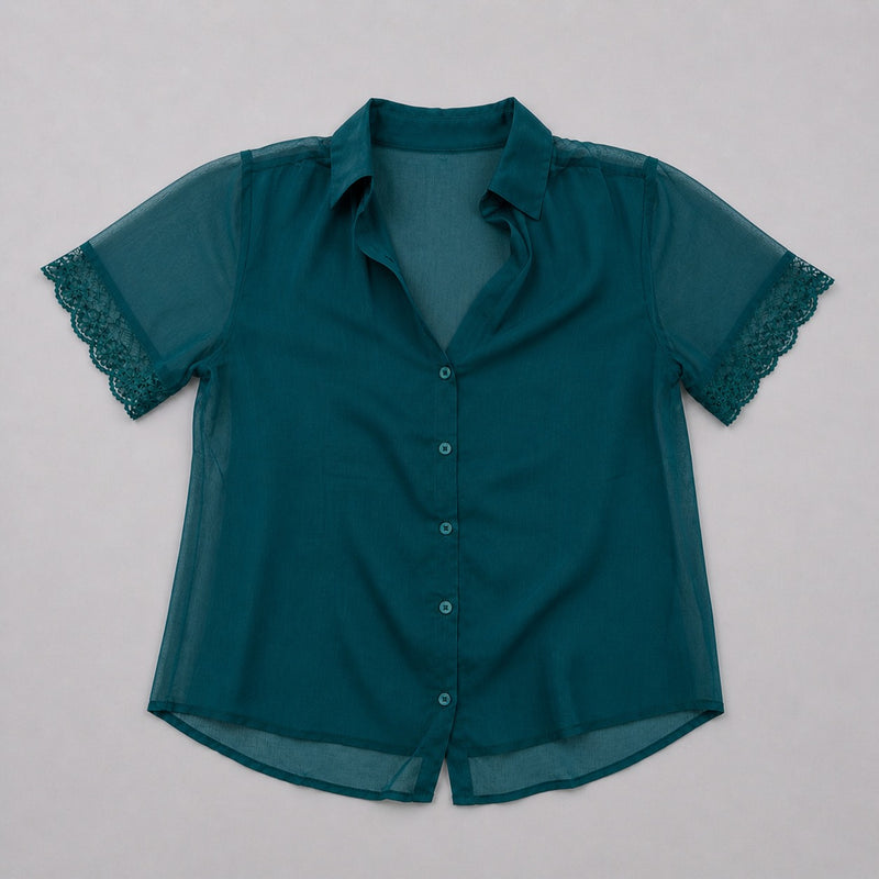 Teal blouse with lace sleeves on a light gray background