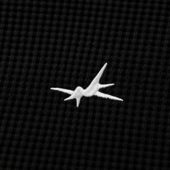 White airplane logo on a black textured background