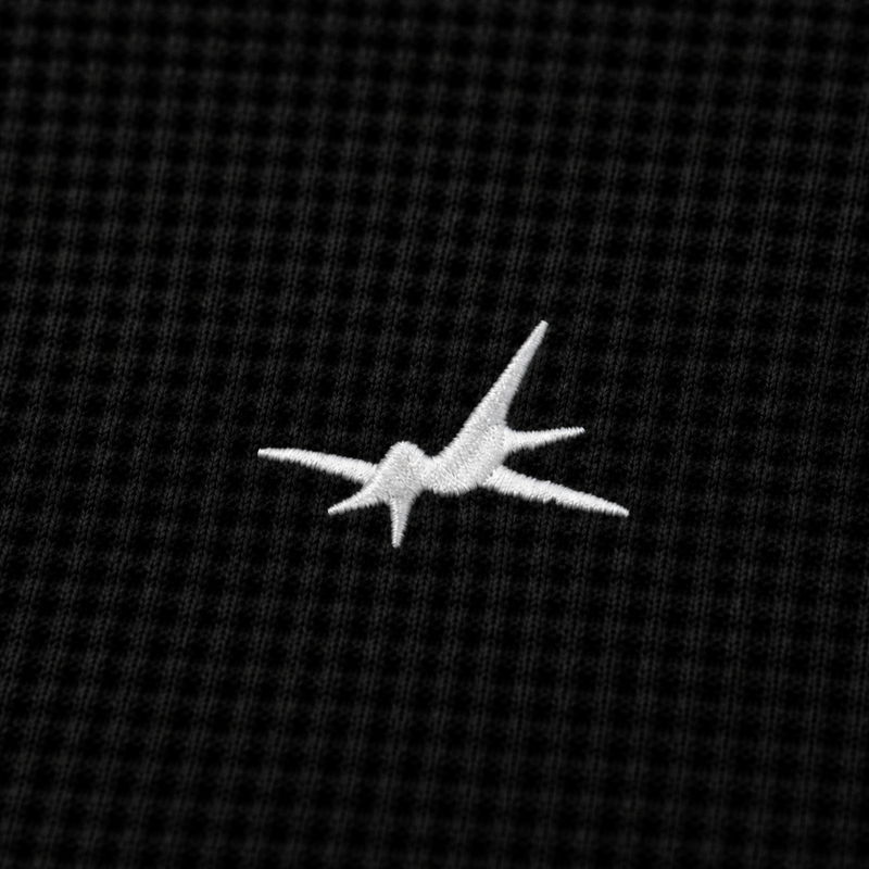 White airplane logo on a black textured background